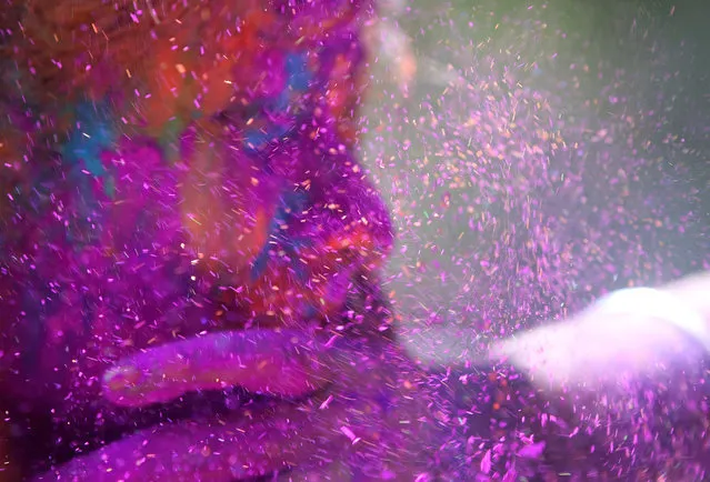 A man smears the face of a woman with coloured powder during celebrations marking Holi, the Hindu festival of colors, in Mumbai, India, Friday, March 6, 2015. Holi, India's joyful and colorful celebration of the arrival of spring along with several religious myths and legends, has long ago ceased to be only a Hindu festival. The streets and lanes across most of India turn into a large playground where people off all faiths throw colored powder and water at each other. (AP Photo/Rajanish Kakade)