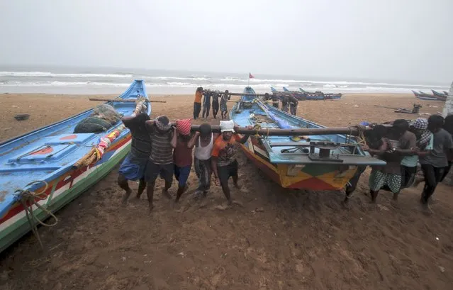 Fishermen shift their boats to safer grounds as a precaution against Cyclone Yaas at the Puri beach on the Bay of Bengalcoast in Odisha, India, Monday, May 24, 2021. The storm was forecast to hit the eastern states of West Bengal and Odisha on Wednesday. (Photo by AP Photo/Stringer)