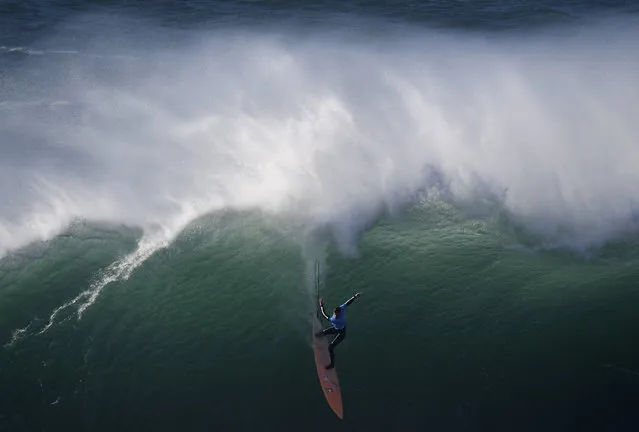 American big wave surfer Nic Lamb drops a wave off Praia do Norte in Nazare, Portugal during the first edition of the World Surf League's Nazare Challenge on December 20, 2016. (Photo by Francisco Leong/AFP Photo)