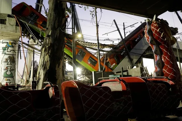 A train is seen at the site where an overpass for a metro partially collapsed at Olivos station in Mexico City, Mexico, May 4, 2021. (Photo by Luis Cortes/Reuters)
