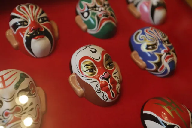 Monkey mask is placed among Beijing Opera masks made by folk artist Zhao Yongqi at his studio, in Beijing, China, January 29, 2016. (Photo by Jason Lee/Reuters)