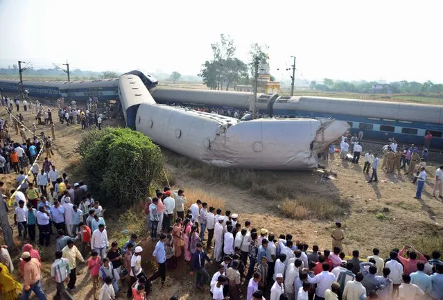 Indian people gather at the site of a train accident near Nashik, 165 kilometers (100 miles) north of Mumbai, India, Friday, November 15, 2013. Police say the passenger train derailed in western India, killing at least two people and injuring another 25. The cause of the accident was not immediately known. (Photo by AP Photo)