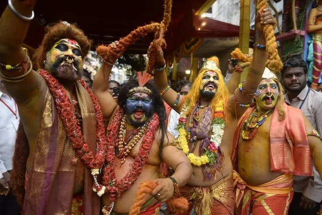 Hindu devotees dressed as Potharaju, the brother of the Hindu goddess Mahakali, perform during the Bonalu festival procession at the Sri Ujjaini Mahakali Temple in Secunderabad, the twin city of Hyderabad on July 18, 2022. (Photo by Noah Seelam/AFP Photo)