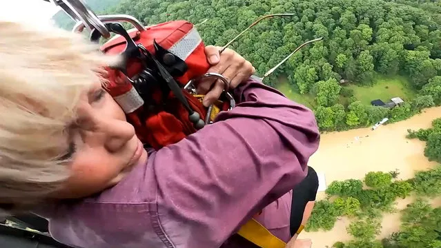 A woman is rescued from flooding by the crew of a U.S. Army National Guard Blackhawk helicopter in eastern Kentucky, U.S. in a still image from video taken July 28-29, 2022. (Photo by Staff Sgt. Shaun Morris/U.S. Army National Guard/Handout via Reuters)