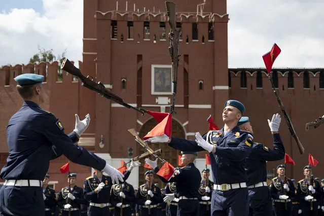 Russian paratroopers demonstrate their skills as they take part in celebrations for Paratroopers Day in front of the Spasskaya Tower in Red Square in Moscow, Russia, August 2, 2022. Six months after Russia sent troops into Ukraine, there's little sign of the conflict on Moscow's streets and the capital's residents seem unconcerned about the economic and political sanctions by Western countries. (Photo by AP Photo/File)