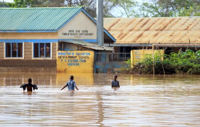 Children wade in floodwater outside the Hatata primary school following heavy rains at Mororo village, in Garissa county, Kenya on November 12, 2023. (Photo by Reuters/Stringer)