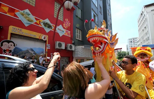 Members of the Chinese community perform a dragon dance as they take part in celebrations to mark the Chinese Lunar New Year, which welcomes the Year of the Monkey, in Sao Paulo, Brazil, February 13, 2016. (Photo by Paulo Whitaker/Reuters)