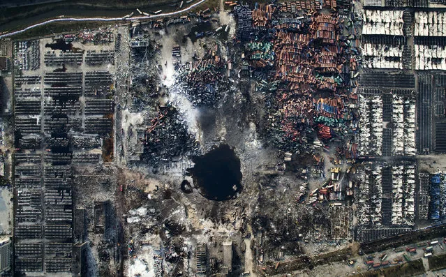 “Tianjin Explosion”. General News, third prize singles. Chen Jie, China. Location: Tianjin, China. Aerial view of the destruction after the explosion in Tianjin, China, August 15, 2015. (Photo by Chen Jie/World Press Photo Contest)