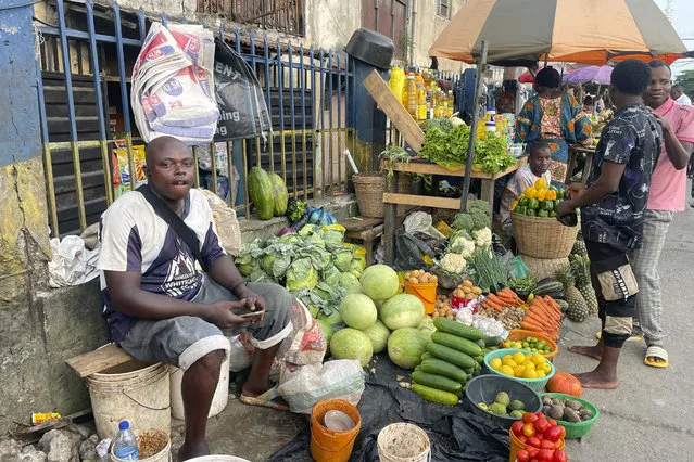 A man sells fruits at a market in Lagos, Nigeria Wednesday , November 29, 2023. Nigeria's leader on Wednesday presented a $34 billion spending plan for 2024 to federal lawmakers with a key focus on stabilizing Africa's largest but ailing economy and fighting the nation's deadly security crisis. (Photo by Sunday Alamba/AP Photo)