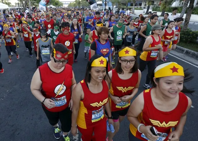 Runners wearing super heroes costumes take part in a DC Comics fun run in Manila April 18, 2015. (Photo by Romeo Ranoco/Reuters)