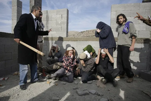 Injured Israeli settlers are detained by Palestinian villagers in a building under construction near the West Bank village of Qusra, southeast of the city of Nablus, Tuesday, January 7, 2014. (Photo by Nasser Ishtayeh/AP Photo)