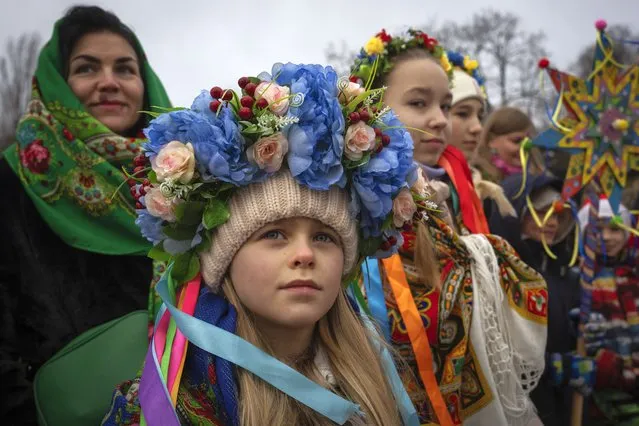 People dressed in national suits celebrate Christmas in the village of Pirogovo outside capital Kyiv, Ukraine, Monday, December 25, 2023. (Photo by Efrem Lukatsky/AP Photo)