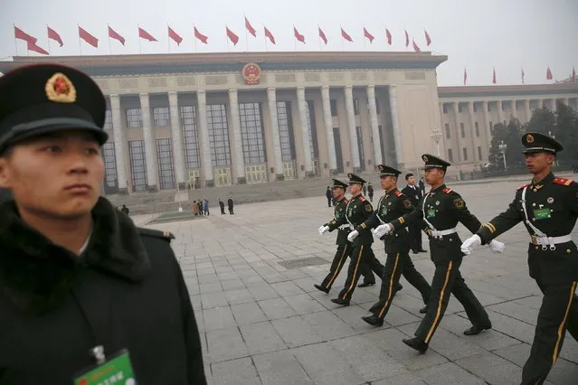 Paramilitary policemen march in front of the Great Hall of the People before delegates arrive for a meeting ahead of Saturday's opening ceremony of the National People's Congress (NPC), in Beijing, China March 4, 2016. (Photo by Damir Sagolj/Reuters)