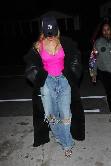 Rihanna rocks a lighter blonde hair style paired with a pink lace corset and a black coat as she steps out for dinner with friends at Italian eatery Giorgio Baldi in Santa Monica on January 15, 2024. The 35-year-old singer is wearing a NY baseball cap, ripped blue jeans, a long black coat, a pink corset shimmering high heels. (Photo by The Hollywood Curtain/Backgrid USA)