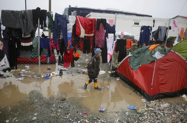 A migrant walks in a mud at a makeshift camp on the Greek-Macedonian border, near the village of Idomeni, Greece March 10, 2016. (Photo by Stoyan Nenov/Reuters)