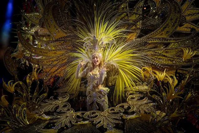 A candidate to Queen of Carnival performs during the Election of the Queen of Carnival gala in Santa Cruz de Tenrife on the Spanish Canary island of Tenerife, on February 7, 2023. The candidates for Queen of the Carnival wear costumes of more than five-meter high and over 80 kilos in weight. Considered one of the most popular and well-known carnival in the world, following Rio de Janeiro (Brazil), the Carnival of Santa Cruz de Tenerife offers festivities that range from the election of the Carnival Queen, children and adult murgas (satirical street bands), comparsas (dance groups) to performances on the streets. (Photo by Desiree Martin/AFP Photo)