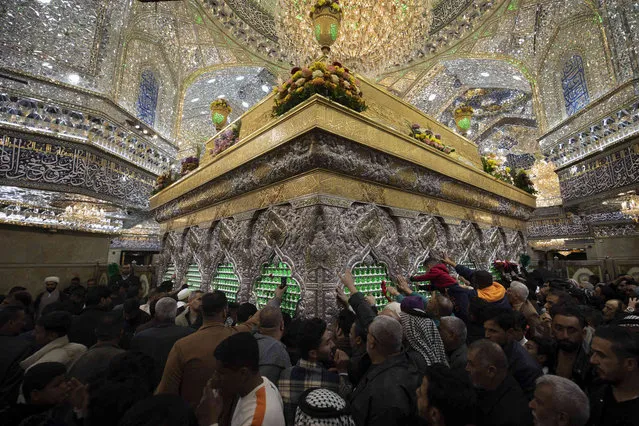 Shiite Muslim pilgrims visit the holy shrine of Imam Hussein in Karbala, Iraq, Friday, January 12, 2024. (Photo by Hadi Mizban/AP Photo)