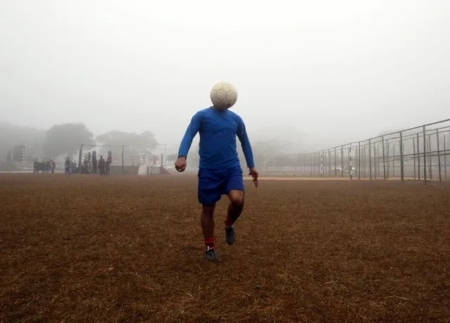 A man controls a ball during his soccer practice in a public park on a foggy morning in Agartala, capital of India's northeastern state of Tripura, in this January 12, 2015 file photo. (Photo by Jayanta Dey/Reuters)