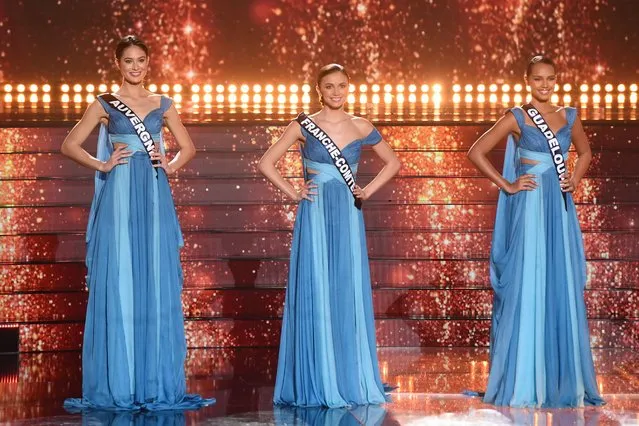 (From L) Miss Auvergne Alissia Ladeveze, Miss Franche Comte Marion Navarro and Miss Guadeloupe Indira Ampiot perform on stage during the Miss France 2023 beauty contest in Deols, central France, on December 17, 2022. (Photo by Guillaume Souvant/AFP Photo)