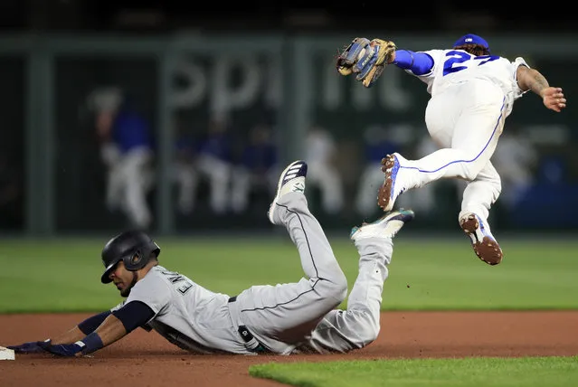 Kansas City Royals shortstop Adalberto Mondesi, right, tags out Seattle Mariners' Edwin Encarnacion, left, during the fourth inning of a baseball game at Kauffman Stadium in Kansas City, Mo., Monday, April 8, 2019. (Photo by Orlin Wagner/AP Photo)