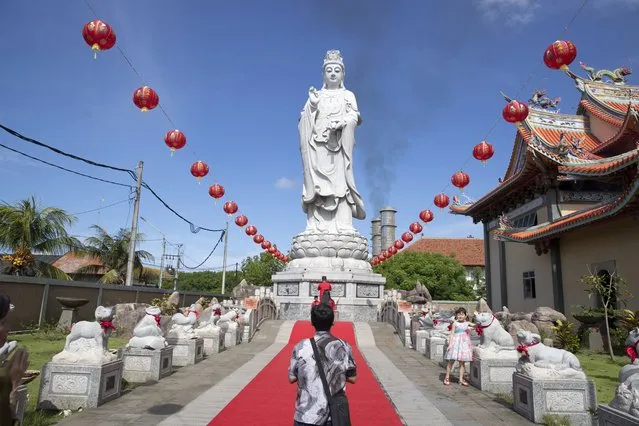 People pray during Lunar New Year celebrations at a temple in Denpasar, Bali, Indonesia, 10 February 2024. The Chinese Lunar New Year, locally known as “Imlek”, falls on 10 February 2024, marking the start of the Year of the Dragon. (Photo by Made Nagi/EPA)