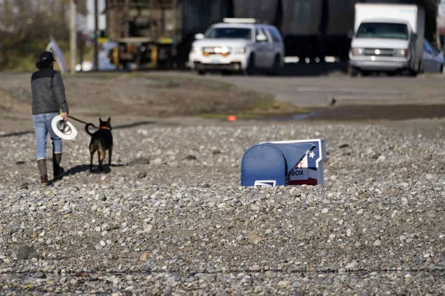 A U.S. Postal Service mailbox sits buried under gravel moved from flood water near a damaged rail yard Wednesday, November 17, 2021, in Sumas, Wash. (Photo by Elaine Thompson/AP Photo)