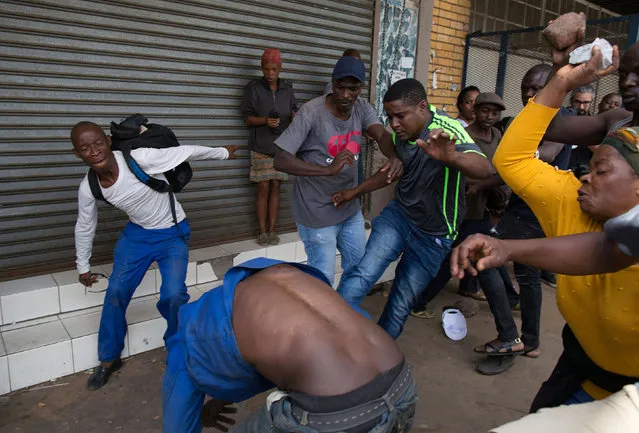 A vigilante mob attacks a Nigerian migrant outside a church in Pretoria, South Africa February 18, 2017. (Photo by James Oatway/Reuters)