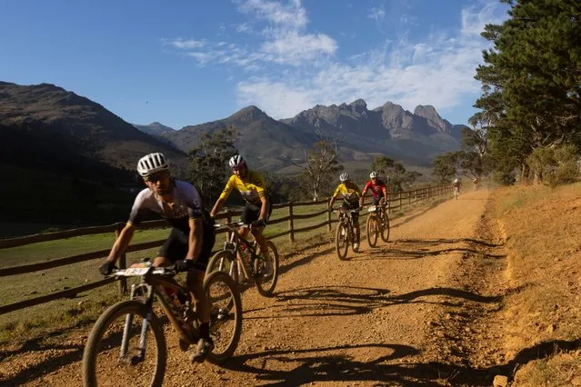 The UCI elite men race with Switzerland's Nino Schurter (L) racing for World Bicycle Relief during Stage 5 of the ABSA Cape Epic MTB race over 70km with 1750m of climbing in Wellington, South Africa, 22 March 2024. (Photo by Kim Ludbrook/EPA/EFE)