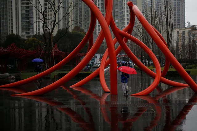 A boy walks with an umbrella at a park in Shanghai, China, February 22, 2017. (Photo by Aly Song/Reuters)