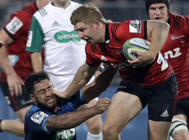 Crusaders Jack Goodhue, right, fends off Blues Akira Ioane during their Super Rugby match in Christchurch, New Zealand, Saturday, May 25, 2019. (Photo by Mark Baker/AP Photo)