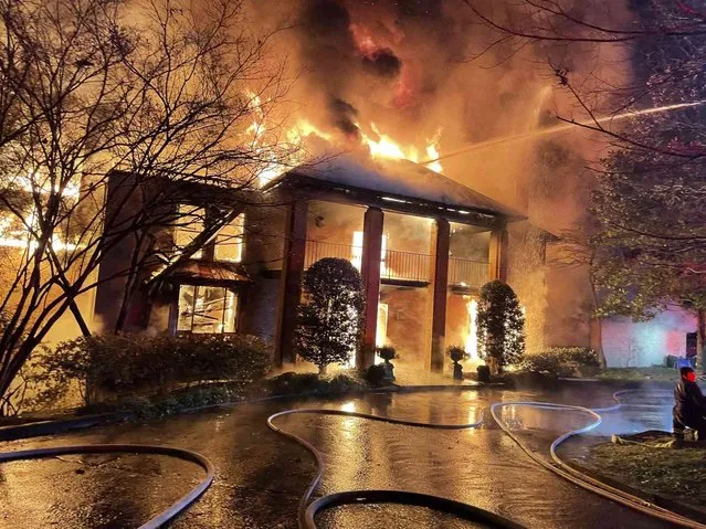 In this image provided by the Fairfax County Fire and Rescue Department, firefighters respond to a fire in McLean, Va., Wednesday, December 22, 2021. Former Sen. Chuck Robb and his wife, Lynda, were hospitalized Wednesday after the fire destroyed their northern Virginia home. Fire officials said the injuries were not life-threatening. (Photo by Fairfax County Fire and Rescue Department via AP Photo)