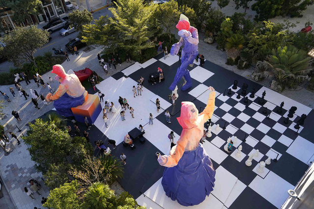 Sculptures and a giant chess set decorate a plaza as part of a Louis Vuitton art installation during Miami Art Week, Friday, December 3, 2021, in the Design District neighborhood of Miami. The project was done under late designer Virgil Abloh who died Sunday at age 41 after a lengthy battle with cancer. Art Week is an annual event centered around the Art Basel Miami Beach fair. (Photo by Lynne Sladky/AP Photo)