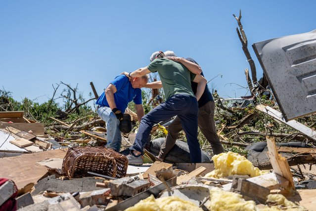 Billy Moles (L),  is prayed for after his home was destroyed llast night by a tornado on May 07, 2024 in Barnsdall, Oklahoma. Barnsdall, a small town with a population of approximately 1,000 people, was struck last night by an EF3 tornado. This latest destruction comes just one week after Oklahoma has been hit with a slew of deadly tornados. (Photo by Brandon Bell/Getty Images)