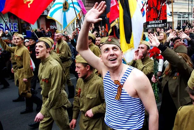 A pro-Russian demonstrator dressed in a Soviet military uniform waves and shouts slogans as he takes part in a rally in the southern Ukrainian city of Odessa on April 10, 2014. Russian President Vladimir Putin threatened on April 10 to cut off Ukraine's gas unless Europe drummed up the cash to help cover its debts in an intensifying standoff over the splintered ex-Soviet state. (Photo by Alexey Kravtsov/AFP Photo)