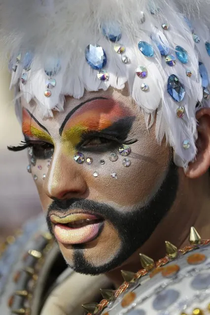 A transvestite, who has chosen the name Ironice, poses during the 15th annual gay pride march to mark International Gay Pride Day, in Santiago, Chile, Saturday, June 27, 2015. Marchers are demanding equal rights for the LGBT community, as well as a Gender Identity Act, and a Ministry for Diversity. (Photo by Jorge Saenz/AP Photo)