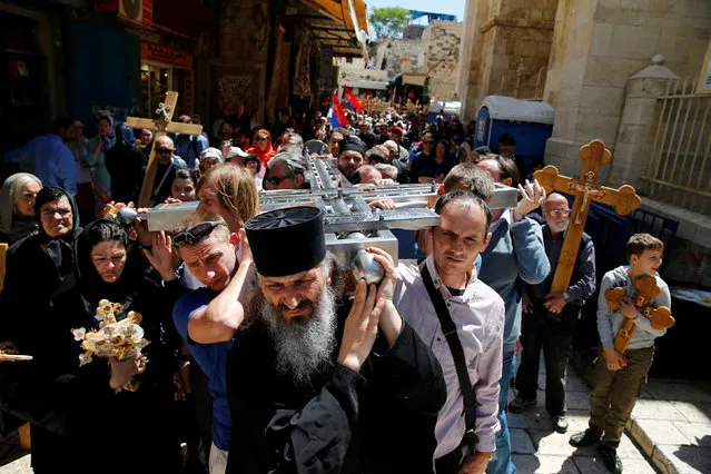 Orthodox Christian worshippers hold crosses before a procession along the Via Dolorosa on Good Friday during Holy Week in Jerusalem's Old City April 29, 2016. (Photo by Ammar Awad/Reuters)