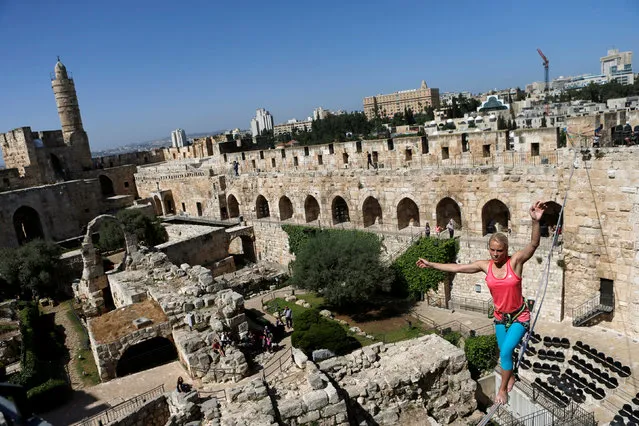 American slackliner Heather Larsen crosses a high wire between two towers at the Tower of David Museum in Jerusalem's Old City May 2, 2016. Wearing a harness attached to the line, Larsen walked across a 35 meter span and then a 20 meter line inside the courtyard of the ancient museum of Jerusalem's Tower of David, named after the Biblical king. (Photo by Nir Elias/Reuters)