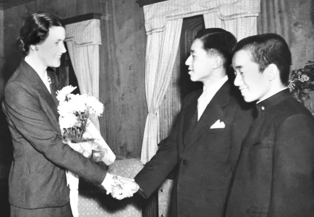 In this December 1, 1950, photo, then Crown Prince Akihito, second from right, shakes hands with his tutor Elizabeth Vining as Vining bids a farewell to him in Yokohama. During the U.S. occupation of Japan after the end of the World War II, he was tutored in English by Elizabeth Vining, a Quaker, an experience that experts say gave Akihito his pacifist and democratic outlook. At right is his brother Prince Yoshinomiya. (Photo by Kyodo News via AP Photo)