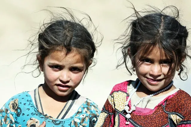 Afghan girls pose for a photograph on the outskirts of Kabul, Afghanistan, Tuesday, June 18, 2019. (Photo by Rahmat Gul/AP Photo)