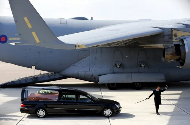 During a decorous ceremony a coffin is driven from the RAF C-17 which carried the bodies of eight British nationals killed in the recent Tunisia beach terror attack, arriving at RAF Brize Norton, England, Friday July 3, 2015. People around Britain paused in streets and workplaces on Friday to honor the victims of an Islamic extremist's rampage at the Tunisian beach resort of Sousse. (Photo by Darren Staples/Pool via AP Photo)