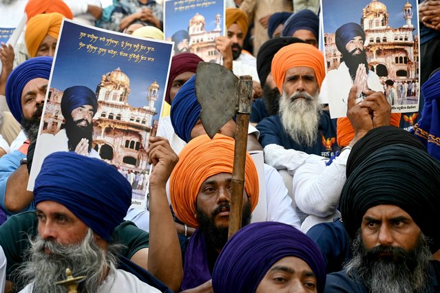 Activists from various Sikh organisations hold placards as they offer prayers on the occasion of the 40th anniversary of Operation Blue Star, at the Golden Temple in Amritsar on June 6, 2024. (Photo by Narinder Nanu/AFP Photo)