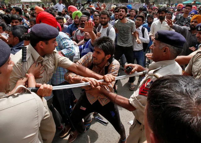 A university student scuffles with policemen during a protest against what the students say is hike in their fees in Chandigarh, India, April 6, 2017. (Photo by Ajay Verma/Reuters)