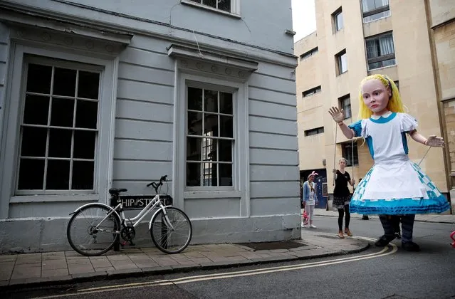 A giant Alice is seen at the 150th anniversary of Lewis Carroll’s Through the Looking Glass celebrations in Oxford, Britain, July 3, 2021. (Photo by Matthew Childs/Reuters)