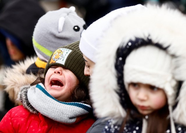 A mother tries to comfort her child as he cries after fleeing the Russian invasion of Ukraine, at the border checkpoint in Medyka, Poland, March 4, 2022. (Photo by Yara Nardi/Reuters)