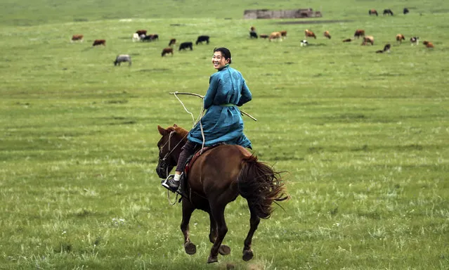 A view of a moorland as a woman riding a horse at Delgerhaan of Khentii, Mongolia on August 18, 2019. In Mongolia, archaeological evidences of horse culture dates back to 3200 years ago. Especially children started to mount horses in vast moorlands at the age of four, maintaining the tradition of horse riding. (Photo by Firat Yurdakul/Anadolu Agency via Getty Images)