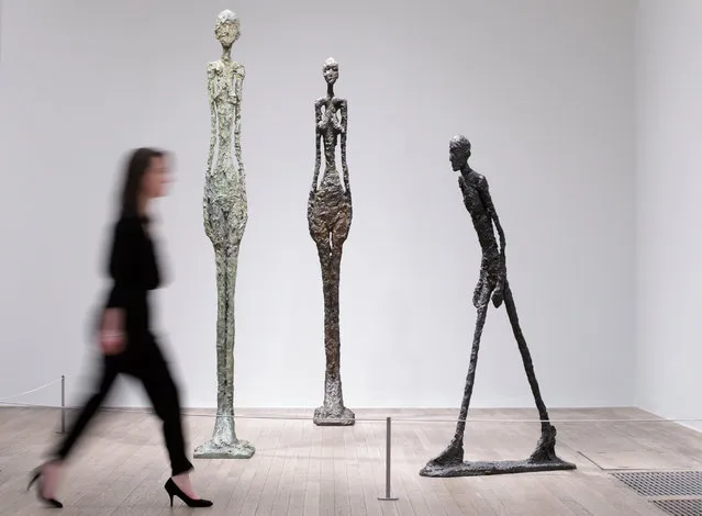 A member of gallery staff poses for a picture with some of the pieces by Swiss artist Alberto Giacometti during a press preview of the new “Giacometti” exhibition at the Tate Modern in London, Britain, 08 May 2017. The exhibition runs from 10 May to 10 September. (Photo by Tim Ireland/EPA)