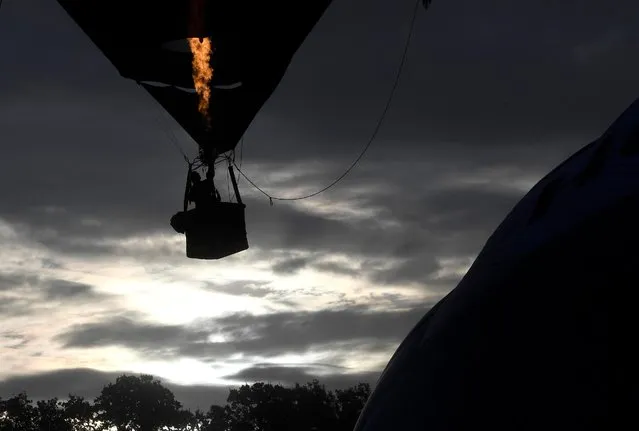 Balloons launch during a mass take off at the annual Bristol hot air balloon festival in Bristol, Britain, August 8, 2019. (Photo by Toby Melville/Reuters)