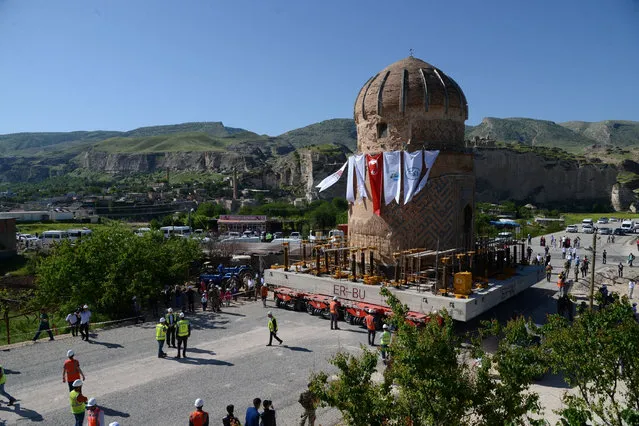 The tomb of Zeynep Bey is carried on a rolling structure on May 12, 2017, at Hasankeyf in Batman, as it is moved to stave off the risk of flooding from a dam project. Turkish authorities on Friday conducted a hugely ambitious and also controversial operation to move an over half- millenium old tomb to new location to stave off the risk of flooding from a dam project. The tomb of Zenyel Bey is a 15 th century memorial to one of the key figures in the Ak Koyunlu tribe who controlled much of eastern Anatolia and the Caucasus and vied for supremacy with the emerging Ottomans. (Photo by Ilyas Akengin/AFP Photo)