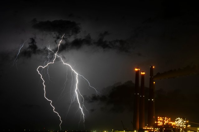 Lightning strikes over Orot Rabin power plant near Hadera, Israel, Monday, April 8, 2024. (Photo by Ariel Schalit/AP Photo)