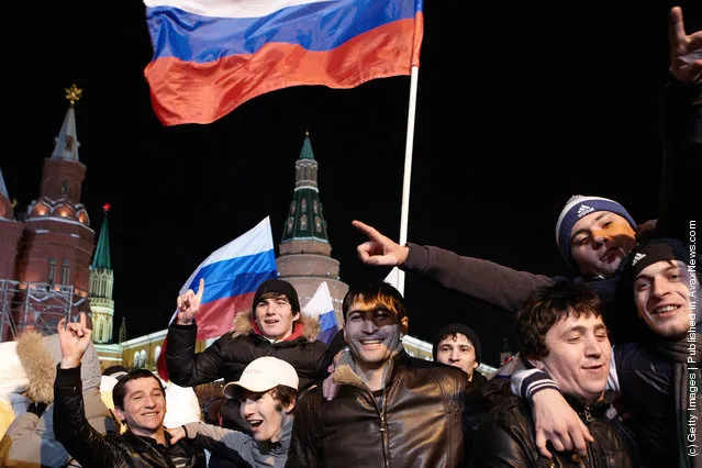 Supporters listen as Russian Prime Minister and presidential candidate Vladimir Putin speaks during a rally after Putin claimed victory in the presidential election at the Manezhnya Square March, 4, 2012 in Moscow, Russia